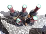 several bottles of wine sitting on top of a marble slab