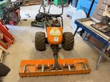 an image of a tractor in a garage with a snow plow
