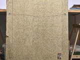 a large piece of cardboard sitting on the floor next to a chair