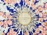 a picture of a floral design on a blue and white table cloth