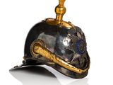 a helmet that has a gold decoration on it