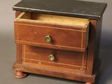 a small wooden box with two drawers on top of it