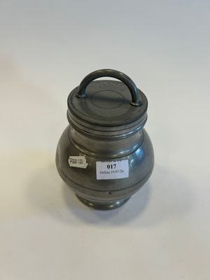 an image of a metal container with a lid on a white surface