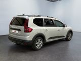 the back end of a white car parked in a showroom