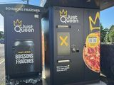 a black and white photo of a vending machine with a pizza on it