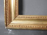 a picture of a picture of a gold frame on the wall