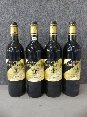 quatre bouteilles de vin sont alignées sur une table