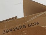 a box that is sitting on a table with a cat inside of it