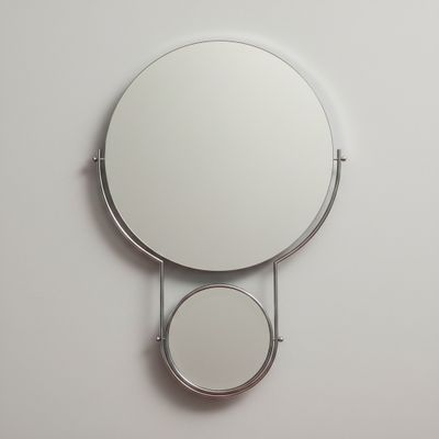 a mirror hanging on the wall with two mirrors on it