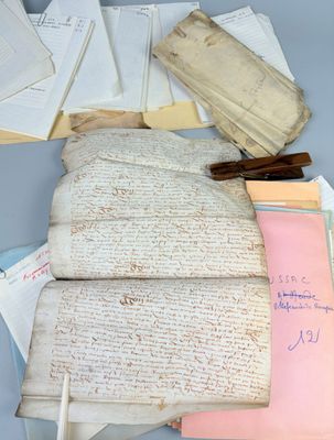 several old papers are piled on top of each other on a table
