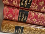 three books are stacked on top of each other on a table