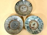 three bowls with designs on them are sitting on a table