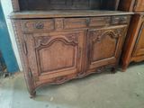 a wooden cabinet with a glass door on top of it
