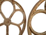 pair of antique cast iron wheels with spokes on white background