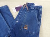 denim pants with a logo on the side and a cell phone in the back