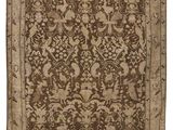 a brown and beige rug with a floral design on it