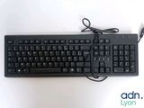 a black keyboard and mouse on a white surface