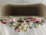 a vase that has shells in it on a table