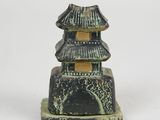 an image of a black and green statue of a pagoda on a white background