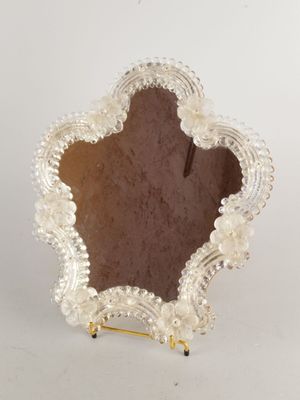 an image of a small mirror with pearls on it