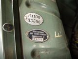 a close up of a green motorcycle with a number plate on it