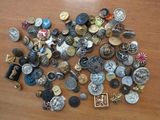 many different types of buttons on a wooden table