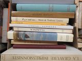 many books stacked on top of each other in a pile