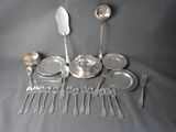 a lot of silverware on a table with spoons and forks