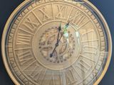 a clock that is sitting on top of a wooden table
