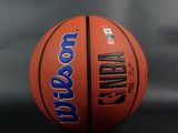 an orange and blue basketball sitting on top of a black table
