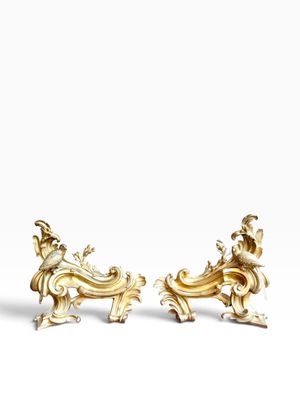 a pair of gold - plated figurines of a man and woman