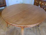 a wooden table with two leaves on it in a room