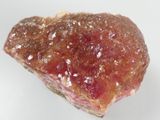 a piece of rock with a pink substance on top of it
