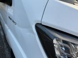 a close up of a car ' s headlight on the street