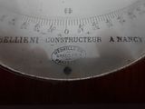 a close up of a scale on a wooden table