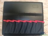 a close up of a black case with red zippers on it