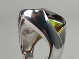 sterling silver ring with yellow topaz stone in center on clear surface