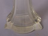 a clear glass vase with a gold top on a table