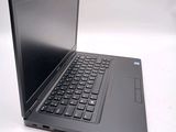 a laptop computer sitting on a table with a keyboard