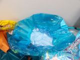 a pile of plastic bags sitting on top of a bed