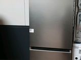 a silver refrigerator and a washing machine in a room