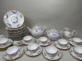 many plates and cups and saucers on the table