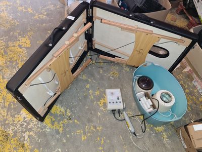 two open suitcases sitting on the floor next to a table