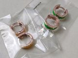 three rings in a clear bag on a table