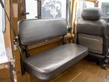 a seat in the back of a bus that is empty