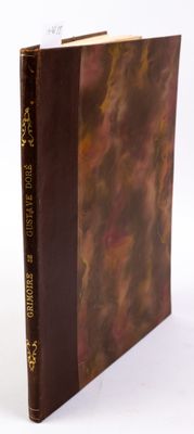 an old book with a brown cover sitting on top of a white surface