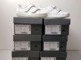 a stack of boxes with a pair of white shoes on top of them