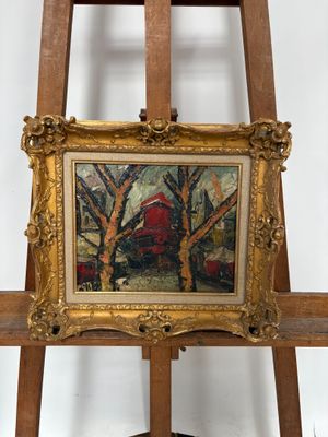 tableau posé sur un chevalet, avec une grange rouge en arrière-plan