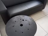a black leather couch and a black coffee table in a room