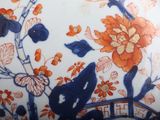 a close up of a vase with flowers and birds on it